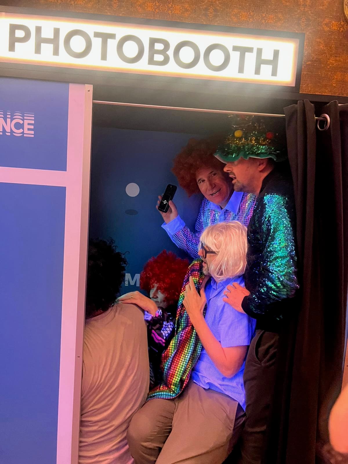 Party guest in a bright wig posing close to camera at a night event