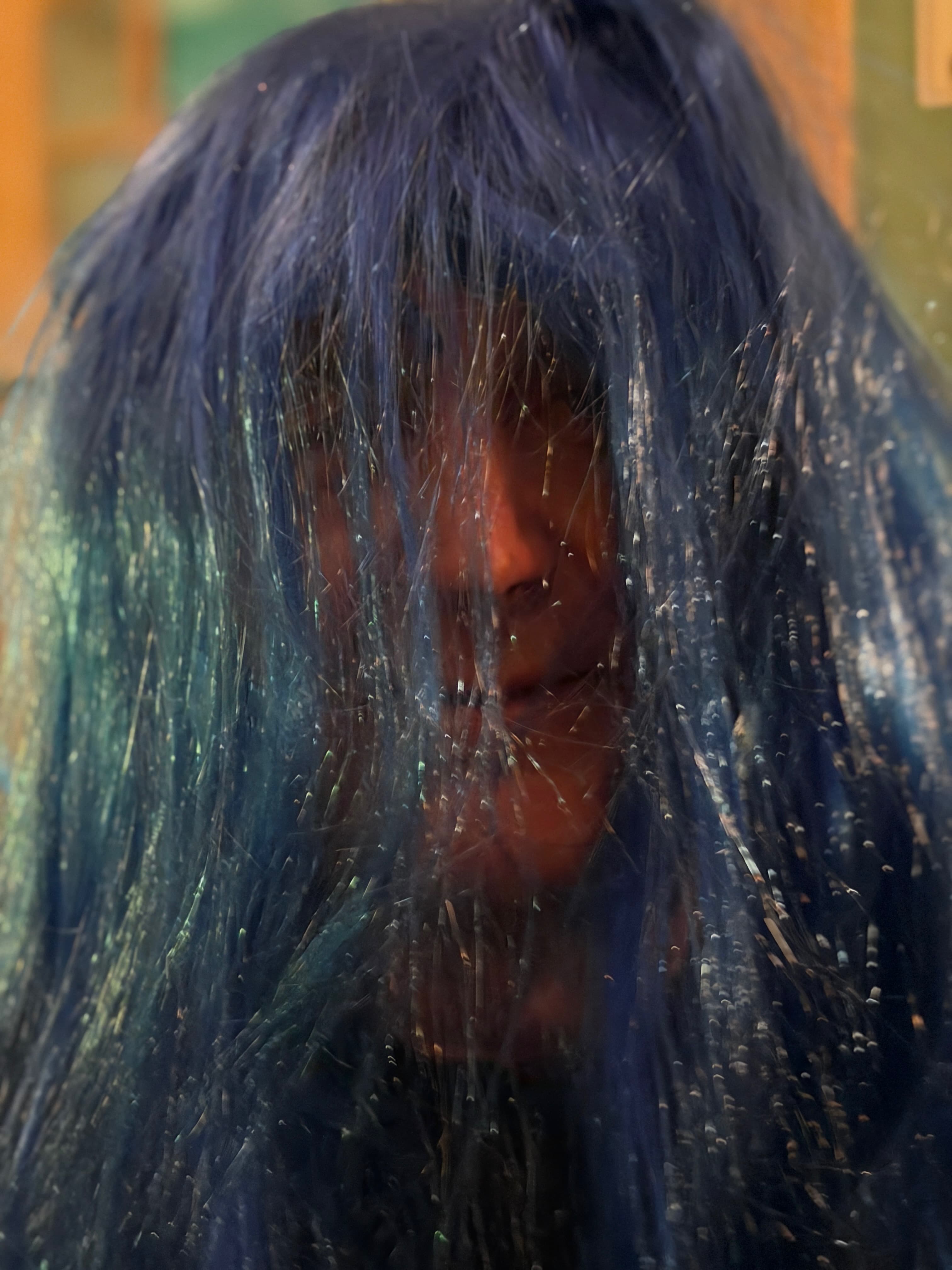 Indoor event shot showing guests in wigs gathered together