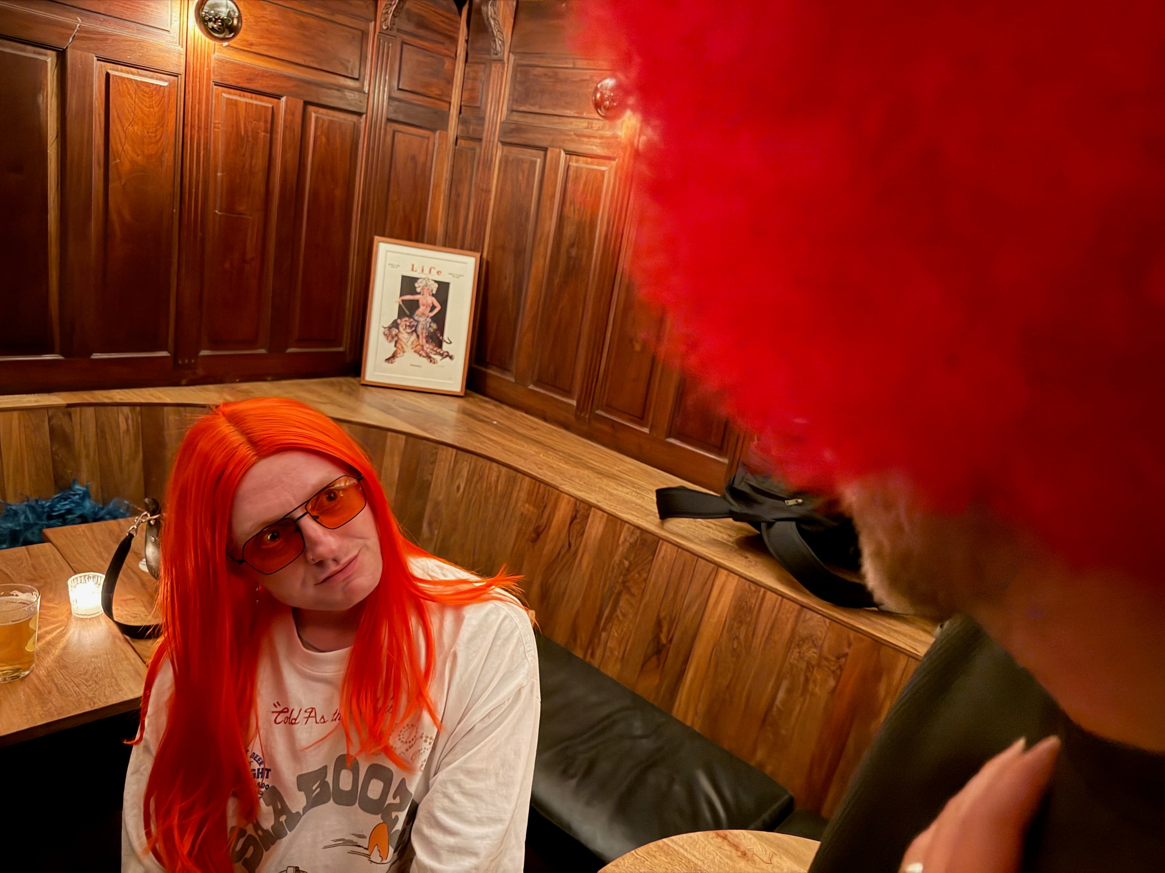 Nightlife portrait with a styled wig and strong color lighting