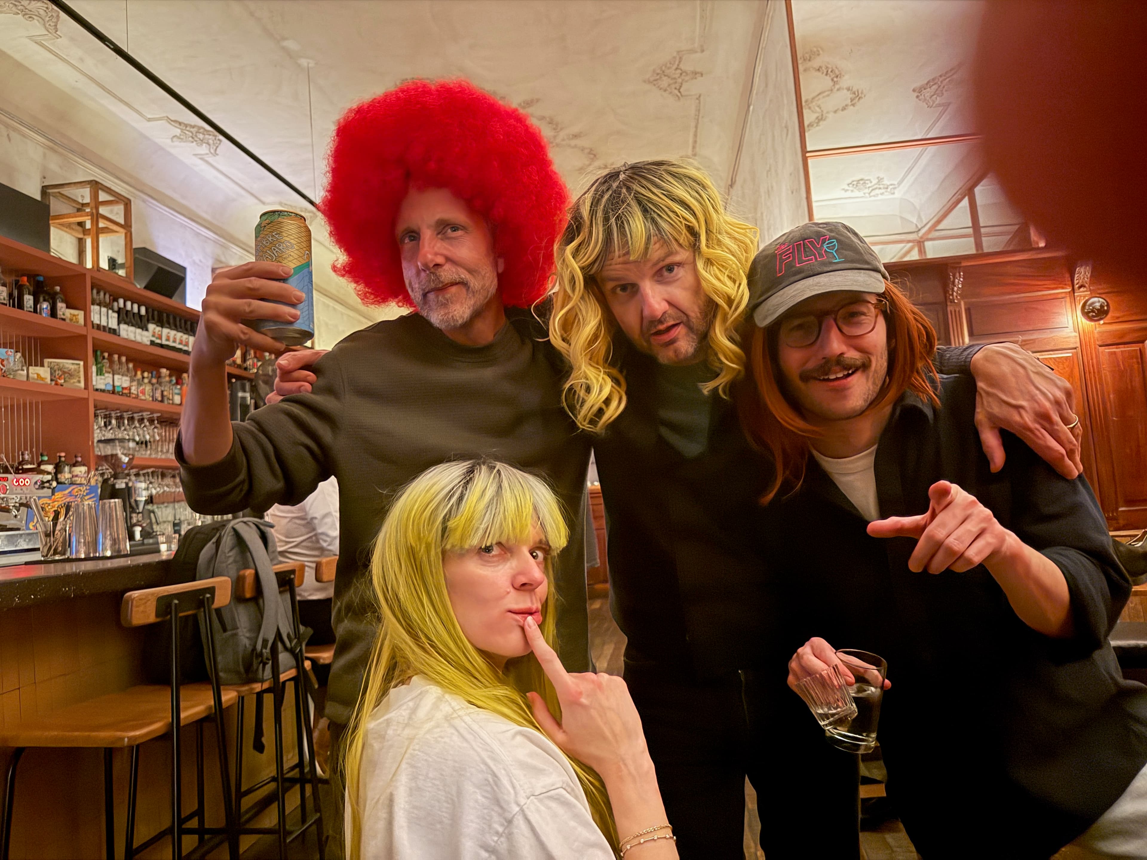 Outdoor night shot of two friends in colorful wigs
