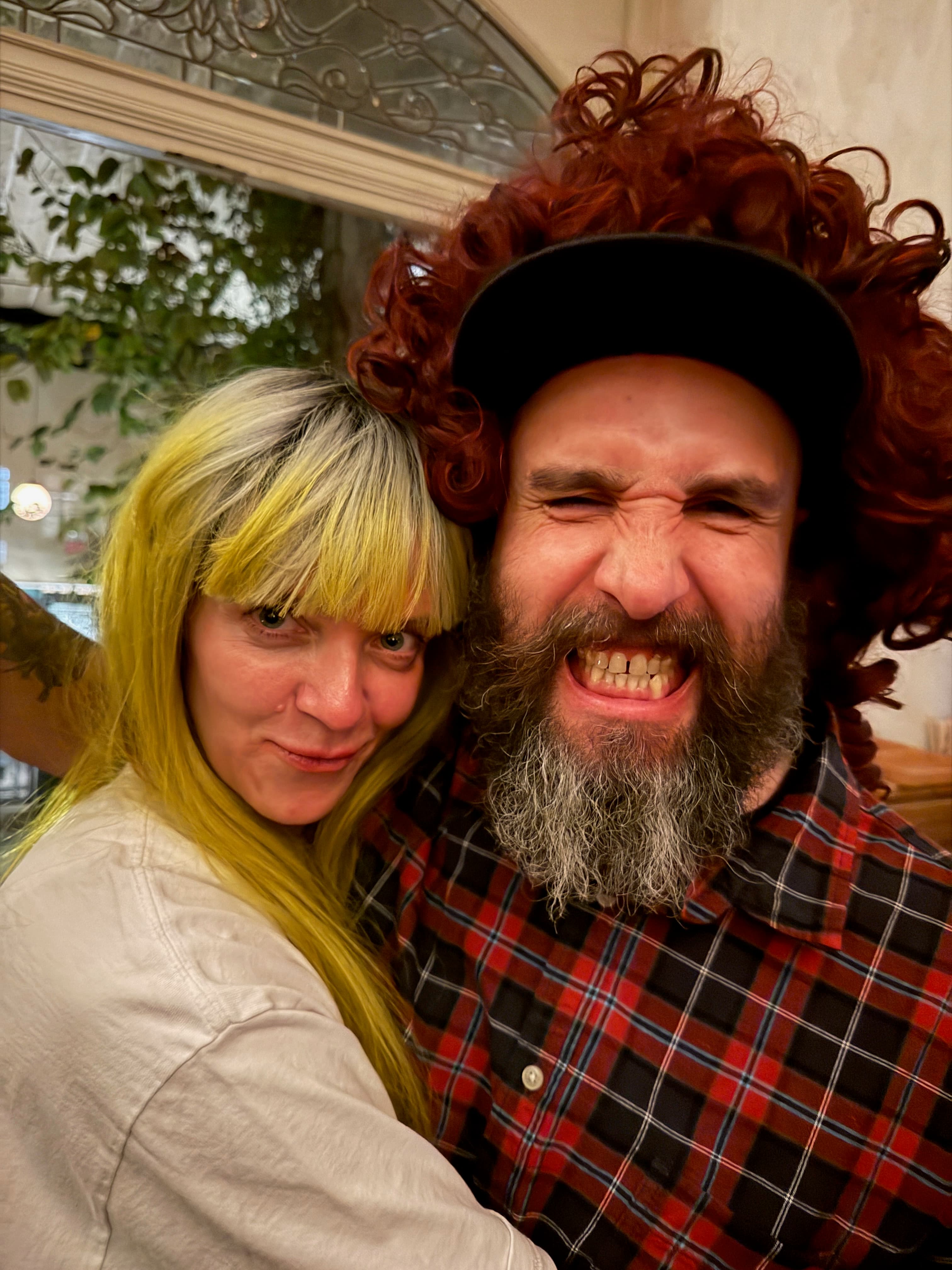 Outdoor party portrait with bright wigs and nighttime street lighting