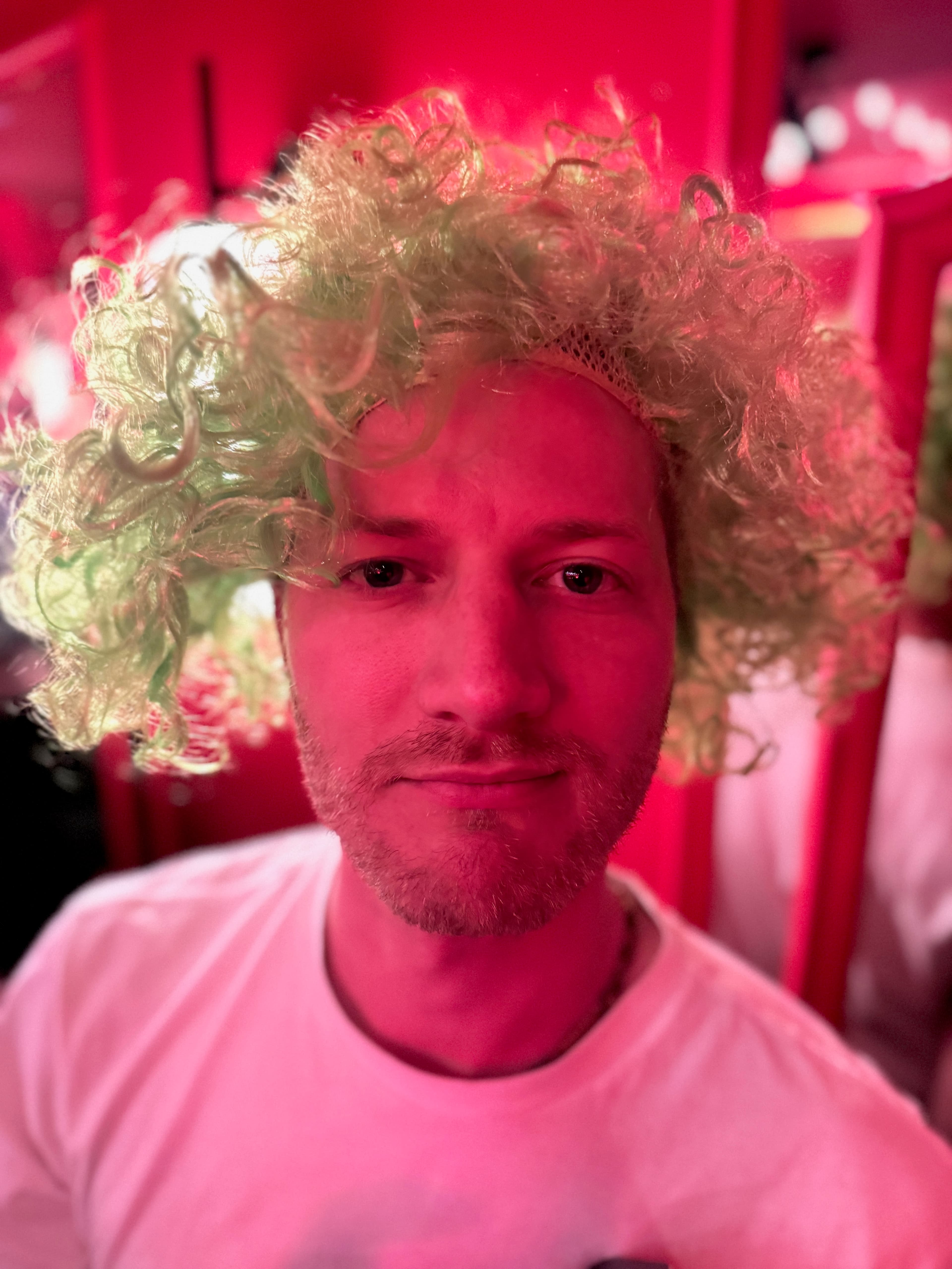 Bold portrait of a guest in a wig at an indoor party