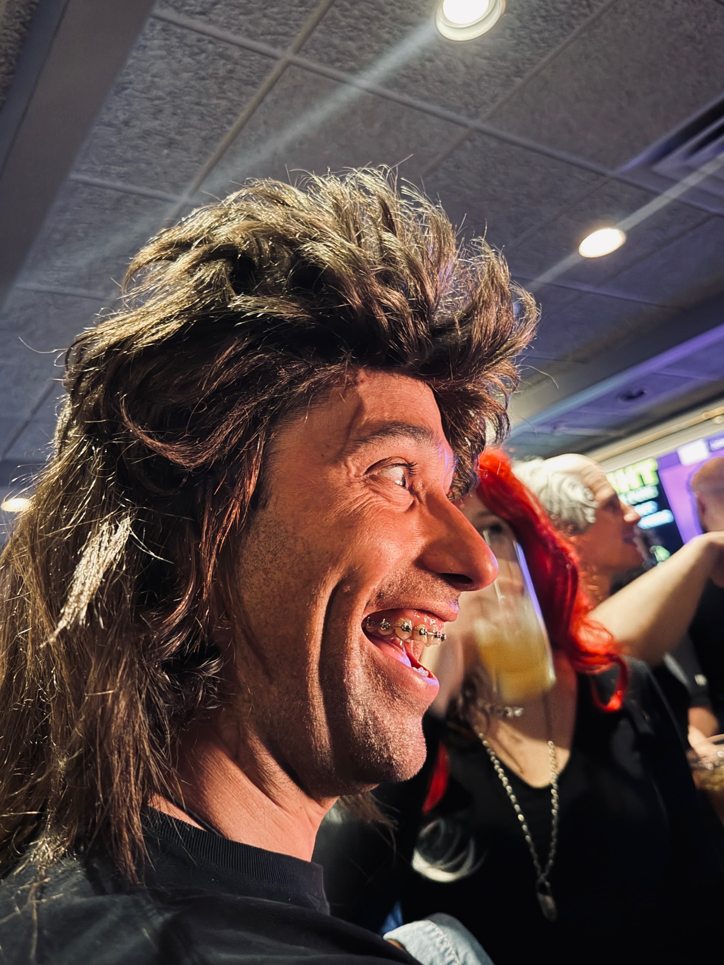 Group of friends in wigs throwing rock hand signs